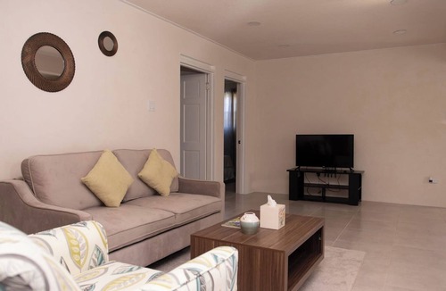 Ragged Point Apartment | The apartment features an open plan living and dining area, and a spacious and modern kitchen.