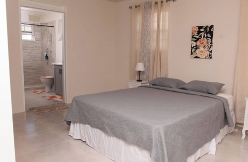 Ragged Point Apartment | The apartment features an open plan living and dining area, and a spacious and modern kitchen.