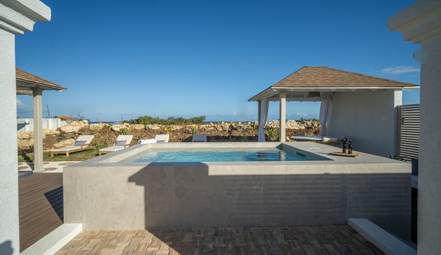 Serene, air-conditioned two-bedroom villa with plunge pool and ocean views. in Belair